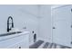 Laundry room with white cabinets, quartz countertop, and black faucet at 2308 1/2 Saint Louis, Tampa, FL 33607