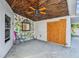 Covered patio with painted wall and ceiling fan at 2472 Trade Winds Dr, Dunedin, FL 34698