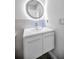 Vanity with modern sink and a sleek, round mirror at 2473 Bentley Dr, Palm Harbor, FL 34684