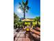 Sunny patio with yellow umbrella and seating area at 2473 Bentley Dr, Palm Harbor, FL 34684