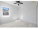 Bright bedroom with window, ceiling fan and marble-look flooring at 2513 W Hiawatha St, Tampa, FL 33614