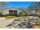 Two-story building with screened balconies and lush landscaping at 300 S Florida Ave # 300G, Tarpon Springs, FL 34689