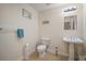 Clean and well-lit half bathroom with pedestal sink and toilet at 322 Ibisview Ln, Apollo Beach, FL 33572