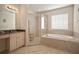 Elegant bathroom with soaking tub, shower, and granite vanity at 322 Ibisview Ln, Apollo Beach, FL 33572