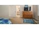 Bedroom with dresser, TV, and ensuite bathroom access at 322 Ibisview Ln, Apollo Beach, FL 33572
