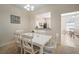 Dining room with white table and chairs adjacent to kitchen at 322 Ibisview Ln, Apollo Beach, FL 33572