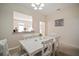 Bright dining room features a white table with six chairs, and view into the living room at 322 Ibisview Ln, Apollo Beach, FL 33572