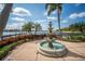 Ornate fountain in a landscaped courtyard, overlooking a lake at 322 Ibisview Ln, Apollo Beach, FL 33572