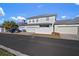 Two-car garage with white fence and a car parked in front at 322 Ibisview Ln, Apollo Beach, FL 33572