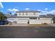 Two-car garage with white fence and a car parked in front at 322 Ibisview Ln, Apollo Beach, FL 33572