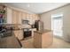 Modern kitchen with stainless steel appliances, granite countertops, and light wood cabinets at 322 Ibisview Ln, Apollo Beach, FL 33572