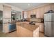 Modern kitchen with stainless steel appliances and granite countertops, island at 322 Ibisview Ln, Apollo Beach, FL 33572