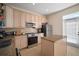 Modern kitchen with stainless steel appliances, granite countertops, and light wood cabinets at 322 Ibisview Ln, Apollo Beach, FL 33572
