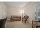 Bright office space with a brown couch, wicker chairs, and neutral-toned walls at 322 Ibisview Ln, Apollo Beach, FL 33572