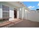 Private patio with brick pavers, white fence, and access to the kitchen at 322 Ibisview Ln, Apollo Beach, FL 33572