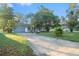 Front view of a single story house with a driveway and lawn at 3370 Lake Padgett Dr, Land O Lakes, FL 34639