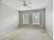 Spacious bedroom with two windows and ceiling fan at 3521 Kings Rd # 102, Palm Harbor, FL 34685