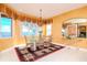 Bright dining room with lake view, glass table, and stylish rug at 36 Freshwater Dr, Palm Harbor, FL 34684