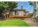 Back exterior view of the house with a wooden deck and lawn at 4426 Helena Ne St, St Petersburg, FL 33703