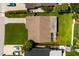 Aerial view of a home with a well-maintained roof, lush green lawn, and ample parking space with long driveway at 4510 Helena Ne St, St Petersburg, FL 33703