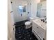 Updated bathroom with walk-in shower, modern vanity, and stylish geometric tile floor at 4510 Helena Ne St, St Petersburg, FL 33703