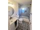 Updated bathroom with stylish vanity, patterned floor, and walk-in shower at 4510 Helena Ne St, St Petersburg, FL 33703