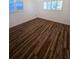 Bright bedroom featuring new wood-look flooring and large windows at 4510 Helena Ne St, St Petersburg, FL 33703