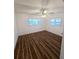 Spacious bedroom with wood-look floors and ceiling fan at 4510 Helena Ne St, St Petersburg, FL 33703