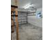Garage with storage shelving and an automatic garage door opener at 4510 Helena Ne St, St Petersburg, FL 33703