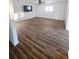 Large living room with wood-look floors and a mounted television at 4510 Helena Ne St, St Petersburg, FL 33703