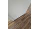 Close-up view of a wall with textured paint and wood-look flooring at 4510 Helena Ne St, St Petersburg, FL 33703