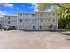 Front view of light blue building with attached garages at 4863 W Flamingo Rd Rd # 2, Tampa, FL 33611