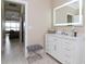 Elegant bathroom with a large vanity, a frameless mirror, and a walk-in closet at 5011 Sandy Brook Cir, Wimauma, FL 33598
