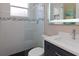 Updated bathroom with walk-in shower, modern vanity, and stylish tile at 5011 Sandy Brook Cir, Wimauma, FL 33598