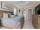 Spacious main bedroom with large bed, dresser, and access to en-suite bathroom at 5011 Sandy Brook Cir, Wimauma, FL 33598