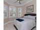 Comfortable bedroom with large windows, neutral decor, and tile flooring at 5011 Sandy Brook Cir, Wimauma, FL 33598
