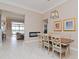Elegant dining room with a modern chandelier and built-in fireplace at 5011 Sandy Brook Cir, Wimauma, FL 33598