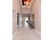 Bright and spacious entryway with tile flooring and elegant chandelier at 5011 Sandy Brook Cir, Wimauma, FL 33598