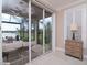 Bright Gathering room with sliding glass doors opening to a relaxing patio and lake view at 5011 Sandy Brook Cir, Wimauma, FL 33598