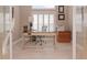 Home office features built-in desk and cabinets, plantation shutters, and tile flooring at 5011 Sandy Brook Cir, Wimauma, FL 33598