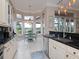 Kitchen features breakfast nook with water view and beautiful cabinetry at 5011 Sandy Brook Cir, Wimauma, FL 33598