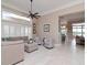 Living Room boasts neutral color palette, comfortable seating, and a view to the backyard at 5011 Sandy Brook Cir, Wimauma, FL 33598