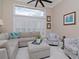 Spacious living area with large windows, comfortable seating, and a neutral color scheme at 5011 Sandy Brook Cir, Wimauma, FL 33598