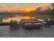 Sunset view from the patio with fire pit and seating at 5011 Sandy Brook Cir, Wimauma, FL 33598
