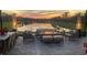 Sunset view from the patio with fire pit and seating at 5011 Sandy Brook Cir, Wimauma, FL 33598