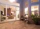 Covered patio with seating area and view of living room at 5011 Sandy Brook Cir, Wimauma, FL 33598