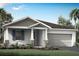 One-story home with gray siding, stone accents, and a two-car garage at 5017 124Th E Ave, Parrish, FL 34219