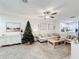 Open concept living room with sectional sofa, coffee table, and a view into the kitchen at 6307 Osprey Lake Cir, Riverview, FL 33578