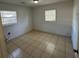 Simple bedroom with tile floors and two windows at 6928 E 29Th Ave, Tampa, FL 33619