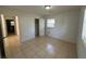 Bedroom with tile floors and access to another room at 6928 E 29Th Ave, Tampa, FL 33619